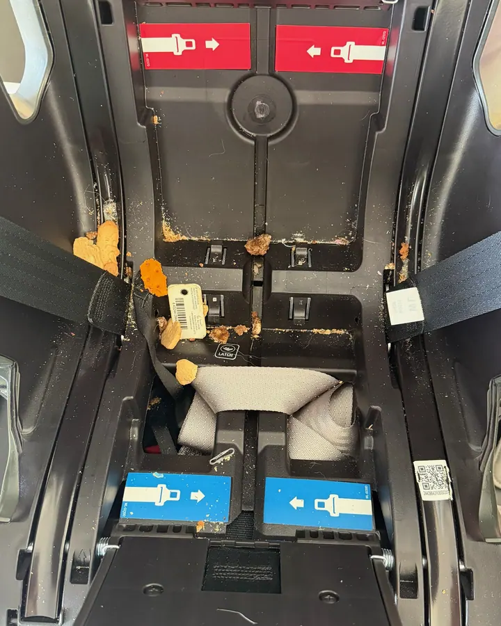 A car seat base crusted with crumbs before cleaning